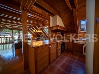 This stunning attic apartment boasts a spacious open-plan living area with large windows offering breathtaking views.
