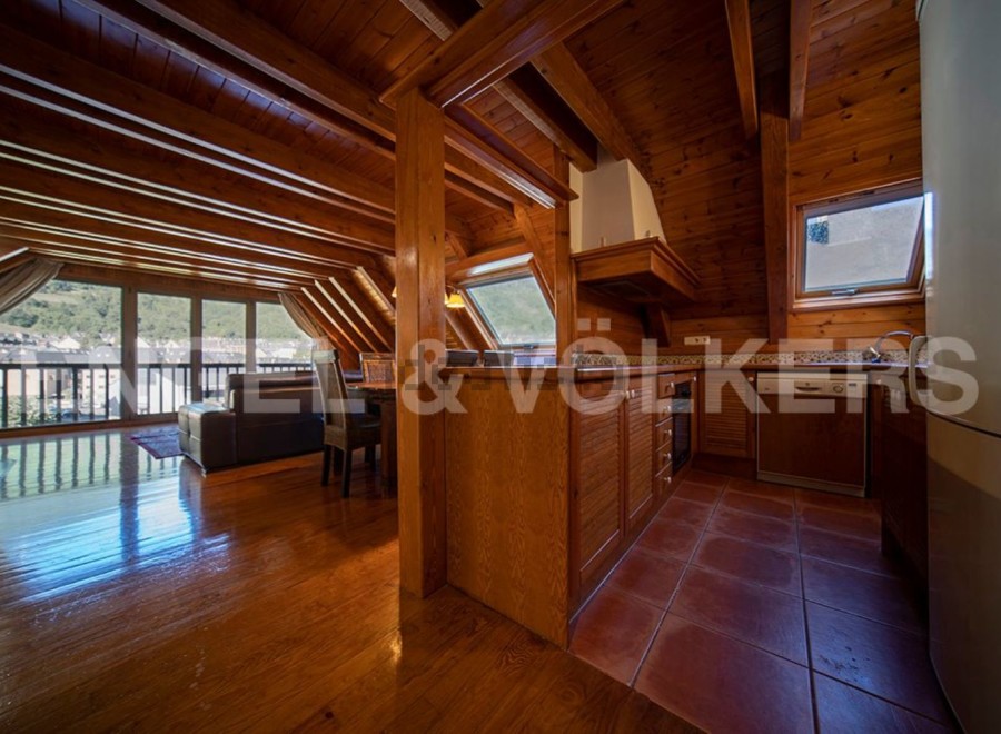 This stunning chalet boasts a spacious open-plan living area with large windows offering breathtaking views.
