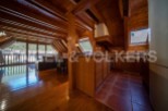 This stunning chalet boasts a spacious open-plan living area with large windows offering breathtaking views.