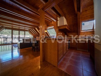 This stunning chalet boasts a spacious open-plan living area with large windows offering breathtaking views.