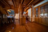 This stunning property boasts a spacious, open-plan living area with gleaming hardwood floors and a charming wooden beamed ceiling.