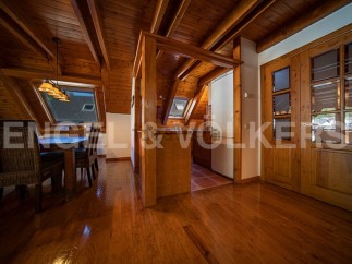 This stunning property boasts a spacious, open-plan living area with gleaming hardwood floors and a charming wooden beamed ceiling.