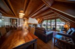 This stunning chalet boasts a spacious open-plan living area with a beautiful wooden ceiling and large windows offering breathtaking views.