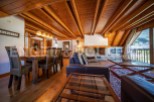 This stunning chalet boasts a spacious open-plan living area with a wood-burning fireplace, perfect for cozy nights in.