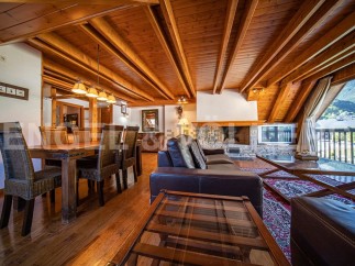 This stunning chalet boasts a spacious open-plan living area with a wood-burning fireplace, perfect for cozy nights in.