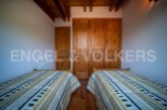 Charming bedroom with twin beds and built-in wooden wardrobe.