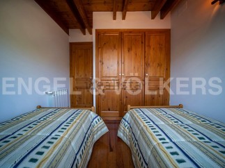 Charming bedroom with twin beds and built-in wooden wardrobe.