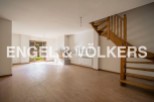 Spacious living area with hardwood floors and a fireplace, perfect for relaxing and entertaining.