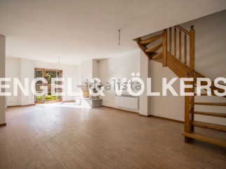 Spacious living area with hardwood floors and a fireplace, perfect for relaxing and entertaining.