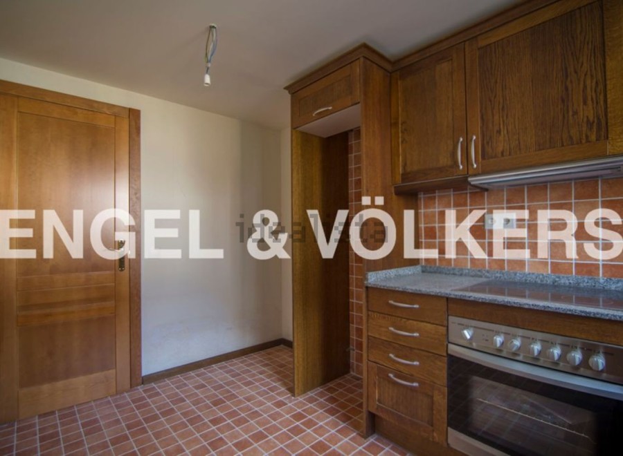 This charming property boasts a well-equipped kitchen with wooden cabinetry and modern appliances.