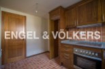 This charming property boasts a well-equipped kitchen with wooden cabinetry and modern appliances.
