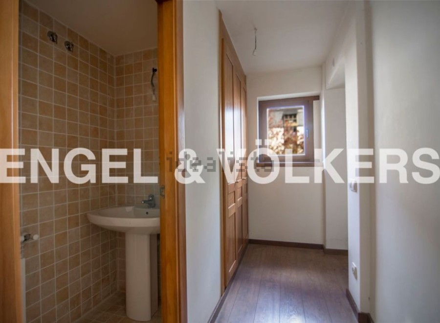 This charming property boasts a well-appointed bathroom with tiled walls and a pedestal sink.