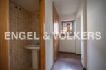 This charming property boasts a well-appointed bathroom with tiled walls and a pedestal sink.
