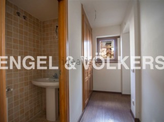 This charming property boasts a well-appointed bathroom with tiled walls and a pedestal sink.
