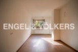 Bright and airy room with hardwood floors and large window offering ample natural light.