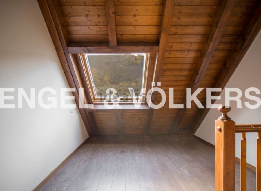 Discover this charming attic room boasting a stunning wooden ceiling and a large skylight that floods the space with natural light.