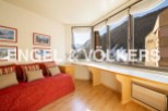Mountain view apartment with a cozy red couch and built-in window seat.