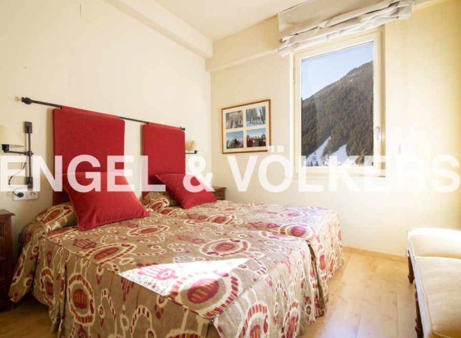 Cozy bedroom with twin beds, featuring a beautiful mountain view.