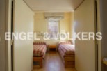 Cozy twin bedroom with built-in closets and a window offering natural light.