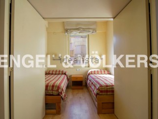 Cozy twin bedroom with built-in closets and a window offering natural light.