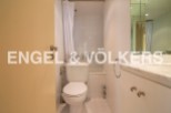 This stunning bathroom boasts a modern design with sleek white fixtures and a bathtub.