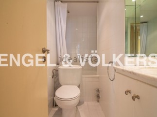 This stunning bathroom boasts a modern design with sleek white fixtures and a bathtub.