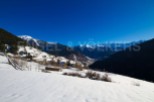 Mountain view home nestled in snowy valley.
