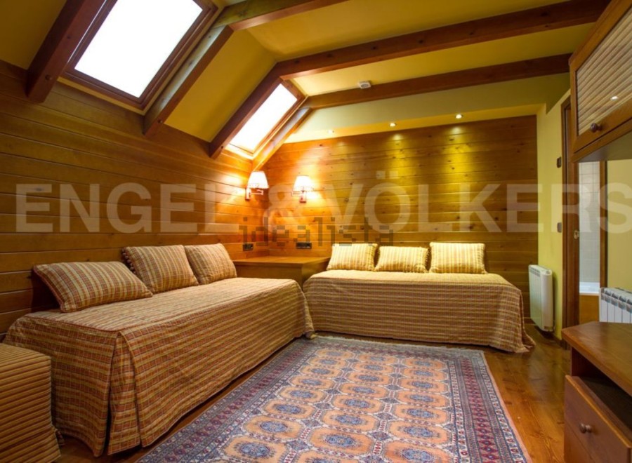 Discover a cozy retreat with this charming bedroom featuring warm wooden accents and inviting daybeds.