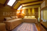 Discover a cozy retreat with this charming bedroom featuring warm wooden accents and inviting daybeds.