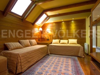 Discover a cozy retreat with this charming bedroom featuring warm wooden accents and inviting daybeds.