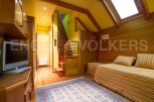 Discover this charming property featuring a cozy living space with wooden accents and a warm ambiance.