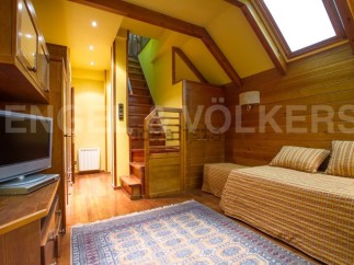 Discover this charming property featuring a cozy living space with wooden accents and a warm ambiance.