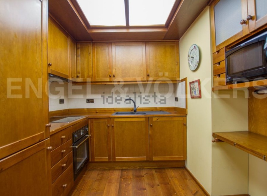 Discover this charming kitchen with its warm wooden cabinetry and inviting atmosphere.