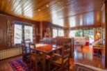 Step into a cozy dining area with a warm wooden ceiling and walls, creating a rustic ambiance.