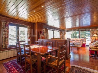 Step into a cozy dining area with a warm wooden ceiling and walls, creating a rustic ambiance.