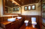 Discover the rustic charm of this bathroom, featuring a stunning wooden vanity with dual sinks.