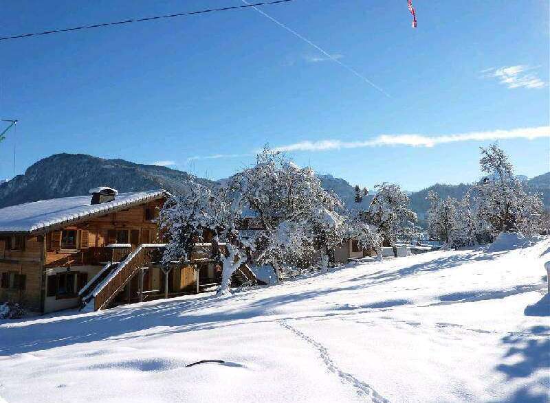 Nestled in a snow-covered landscape, this charming chalet offers breathtaking mountain views.
