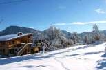 Nestled in a snow-covered landscape, this charming chalet offers breathtaking mountain views.