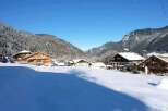 Nestled in a picturesque snow-covered valley, this charming chalet offers breathtaking mountain views.