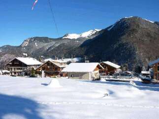 Nestled in a snow-covered mountain village, this charming chalet offers breathtaking views and a peaceful atmosphere.