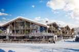 Luxury ski resort nestled in a snowy mountain setting.