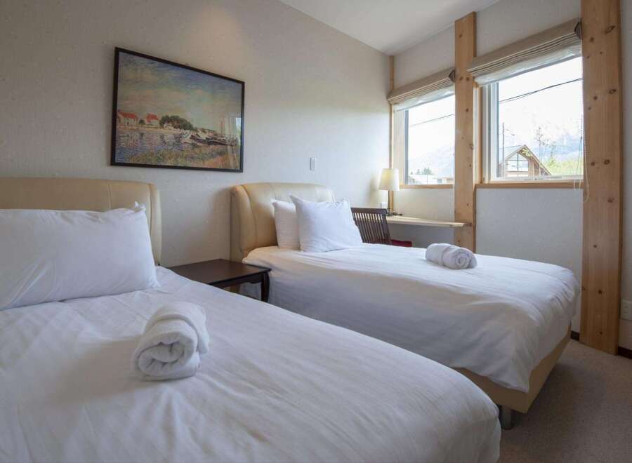 This cozy bedroom features two twin beds, perfect for guests or roommates.