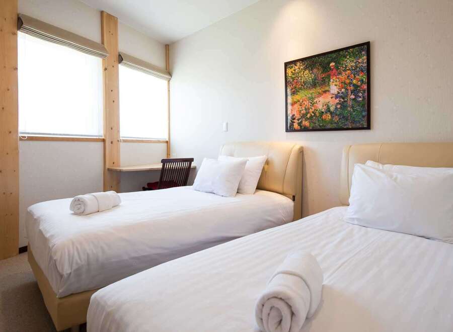 This cozy bedroom features two comfortable beds, perfect for a relaxing stay.