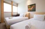 This cozy bedroom features two comfortable beds, perfect for a relaxing stay.