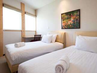 This cozy bedroom features two comfortable beds, perfect for a relaxing stay.