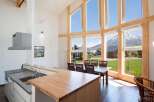 Experience the epitome of modern living in this stunning property, boasting expansive windows that frame breathtaking mountain views.