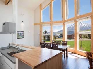 Experience the epitome of modern living in this stunning property, boasting expansive windows that frame breathtaking mountain views.