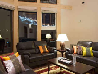 Experience luxury living in this stunning property, featuring a spacious living room with comfortable leather sofas and elegant decor.