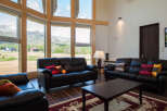 Experience the tranquility of this stunning property, featuring expansive windows that frame breathtaking mountain views.