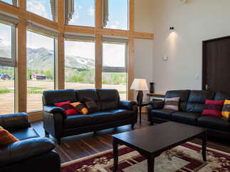 Experience the tranquility of this stunning property, featuring expansive windows that frame breathtaking mountain views.
